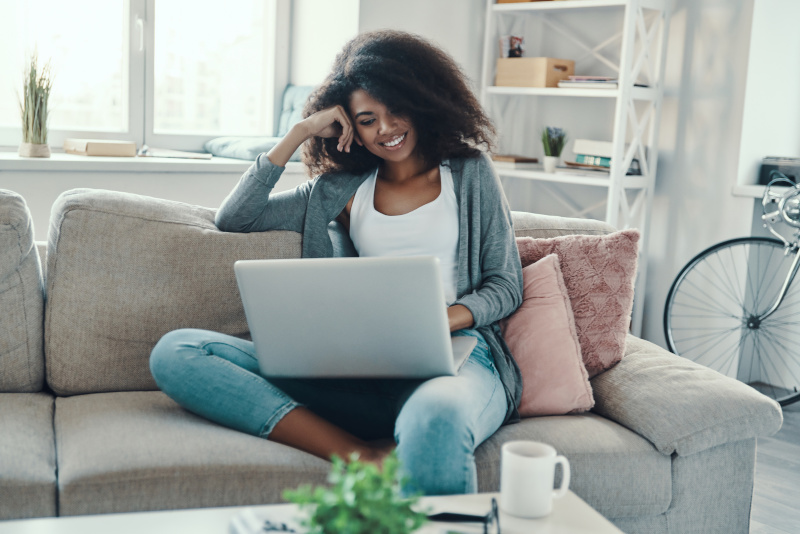 woman enjoying streaming 4k films using her fast fibre broadband connection